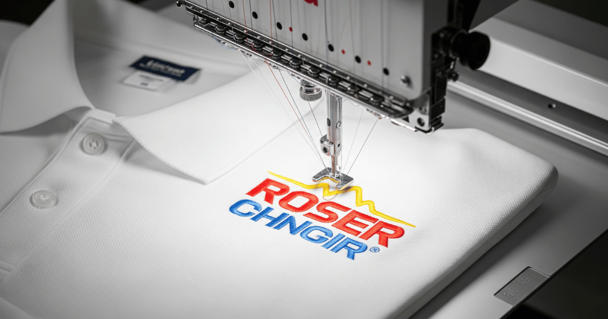 An embroidery machine stitching a digitized logo on a polo shirt
